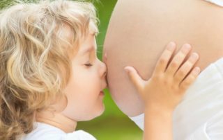Boy Cuddles Mother without breast cancer